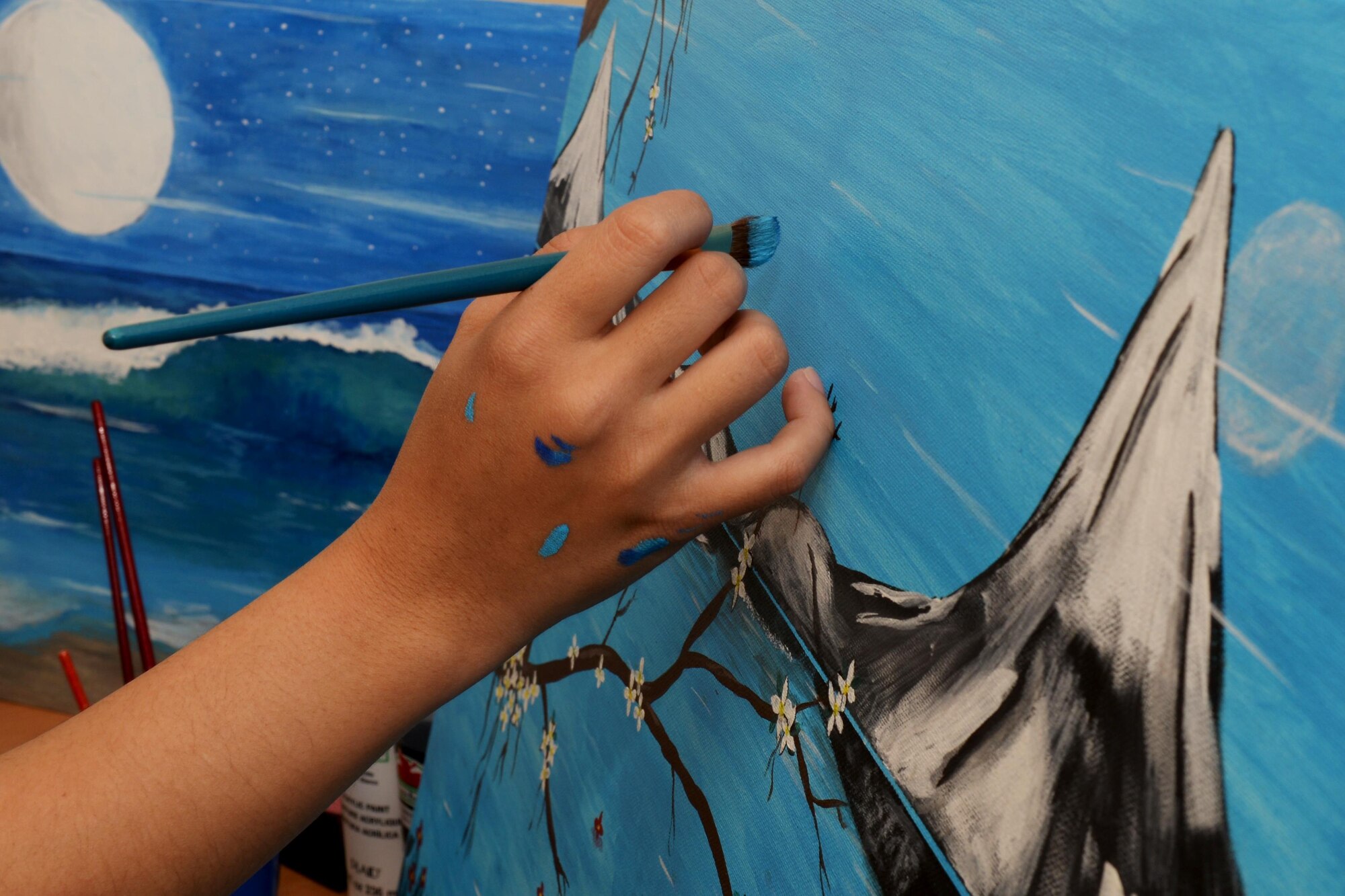 U.S. Air Force Senior Airman Regine Labarda, 100th Comptroller Squadron relocation technician, paints a scenery painting Oct. 17, 2016, in England. Labarda helps base personnel file their travel vouchers as they in-process. In her spare time she enjoys painting. (U.S. Air Force photo by Airman 1st Class Tenley Long)