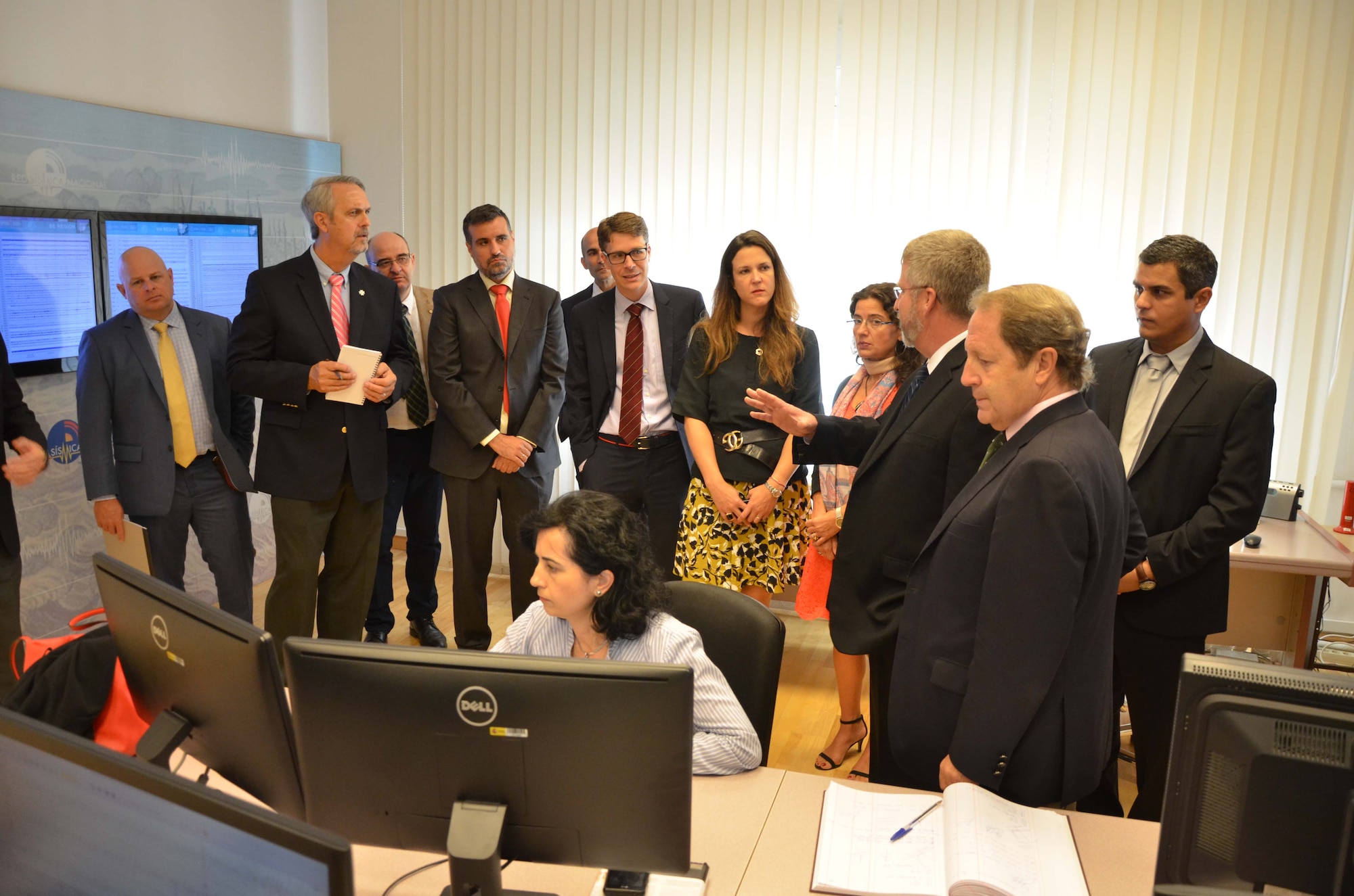 David Merker, Senior Executive Service Director of the U.S. National Data Center (center right, gesturing), explains how the USNDC uses seismic data to monitor nuclear treaties to senior members of Instituto Geográfico Nacional, a multi-faceted agency in Madrid responsible for many aspects of research and development, including geophysics, seismometry and regional volcanic activity analysis, as well as cartography and astrophysics.  Merker and his team of seismic experts traveled to Spain Sept. 19, 2016 to explore possibilities of a future scientific partnership with the IGN. (U.S. Air Force photo by Susan A. Romano)