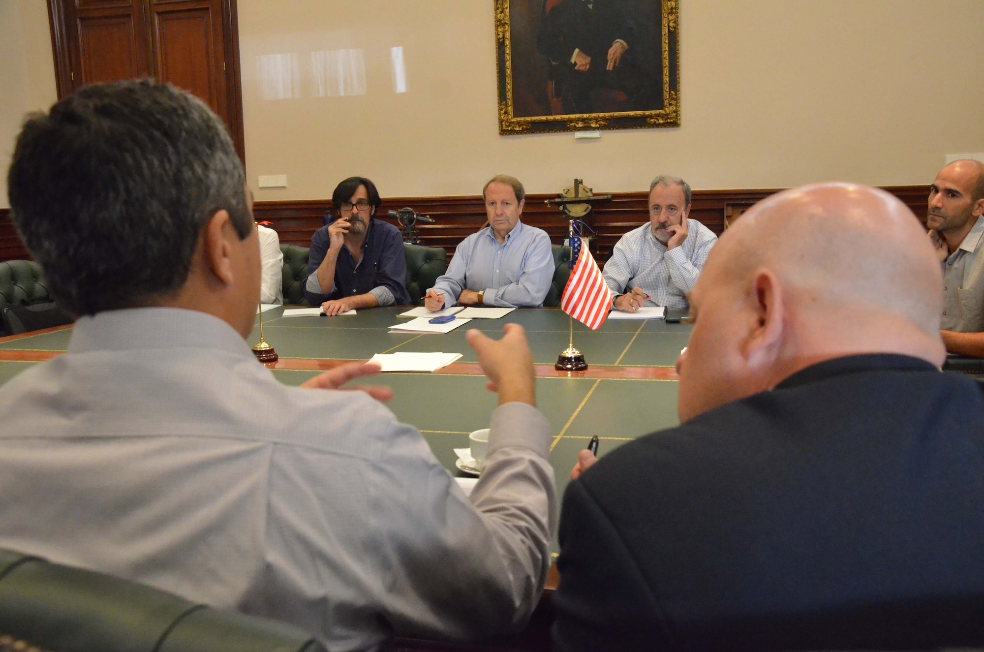 (In foreground) Geophysicist Jorge Román-Nieves, left, and chief of International Affairs Robert McLaughlin, both members of the Air Force Technical Applications Center at Patrick AFB, Fla., discuss seismic operations with their Spanish counterparts at the Instituto Geográfico Nacional in Madrid when they traveled to Spain to look into the possibility of collaborating on joint research projects in the future.  Seen from left to right in background are Jaime Barco, IGN information technology expert; Dr. Emilio Carreño Herrero, director of IGN’s National Seismic Network; José Manuel Martínez Solares, IGN’s chief of geophysics; and Juan Vincente Cantavella, IGN’s chief of seismic services.  (U.S. Air Force photo by Susan A. Romano)