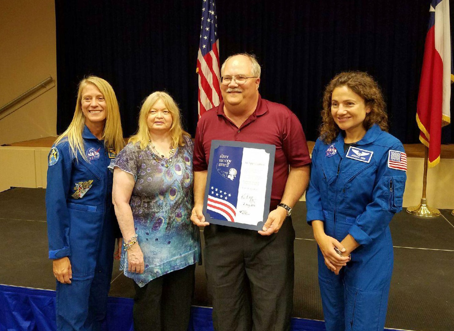 Lewis Godfrey, Defense Contract Management Agency NASA Product Operations quality assurance specialist, and his wife Lois, stand with astronauts Karen Nyberg and Jessica Meir following the presentation of the Silver Snoopy award during a ceremony held at the Johnson Space Center in Houston in August. (Courtesy photo)