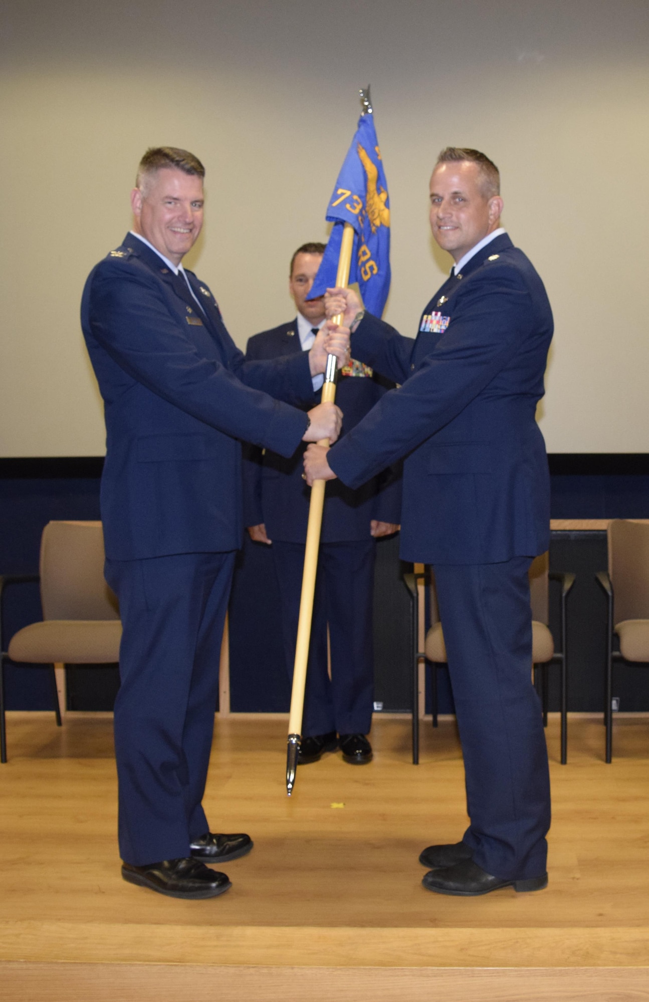 Col. Gregory P. Hayes, 433rd Operations Group commander (left), presents the 733rd Training Squadron guidon to new commander, Lt. Col. Marc Mulkey, during the 733rd TRS Change of Command Ceremony at Joint Base San Antonio-Lackland, Texas, Oct. 16, 2016. Mulkey comes to the 733rd TRS after having served as commander of the 68th Airlift Squadron over the last two years. (U.S. Air Force photo by Tech. Sgt. Lindsey Maurice)