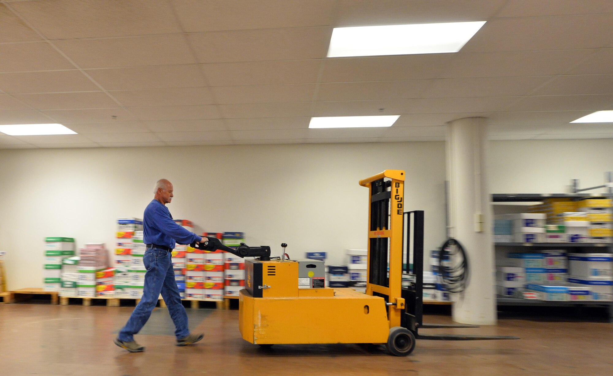 Joe Knott, an electronic duplicating systems technician with Defense Logistic Agencies Document Services, walks along the supply section of the print shop located in the Martin Bomber building on Oct. 11, Offutt Air Force Base, Neb.  Though the demand for print is still there, the DLA print shop has decreased in scale from its original 35,000 square foot facility to 8,000 square feet today.  