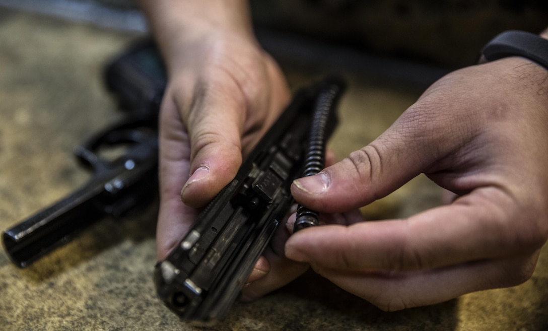Cpl. Chris Sagan conducts a maintenance check on a Beretta M9 pistol at III Marine Expeditionary Force Headquarters Group armory, on Camp Hansen, Okinawa, Japan, October 12, 2016. As a non-commissioned officer, Sagan’s job at the armory is to supervise his junior Marines as well as help with maintenance and repairs to the weapons.  A big part of the Marine Corps is weapons maintenance and accountability. Sagan from Dalton, Pennsylvania, is a small arms repair technician for III MHG, III MEF. (U.S. Marine Corps photo by Cpl. Jessica Etheridge / Released)