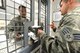 U.S. Air Force Senior Airman Malik Henriques, 88th Security Forces patrolman,receives his M-9 pistol and ammunition from Senior Airman Vernon Harrison, 88 SFS armorer specialist, before his daily tour of duty at Wright Patterson Air Force Base, Ohio, Sept. 13, 2016.The 88 SFS Armory stores and issues a variety of weapons, communication devices and tactical gear for use in the field. (U.S. Air Force photo/Al Bright)