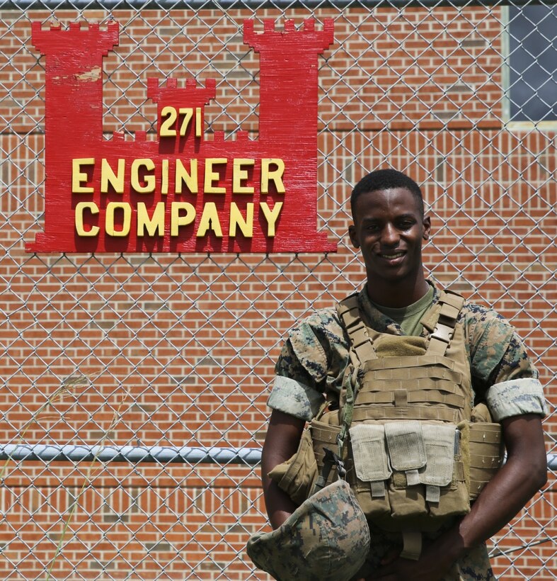 Lance Cpl. Levi Armentrout poses in front of his unit logo aboard Marine Corps Air Station Cherry Point, N.C., Aug. 30, 2016. Armentrout is a combat engineer assignted to Marine Wing Support Squadron 271, Marine Aircraft Group 14, 2nd Marine Aircraft Wing. (U.S. Marine Corps photo by Lance Cpl. Cody Lemons/ Released)