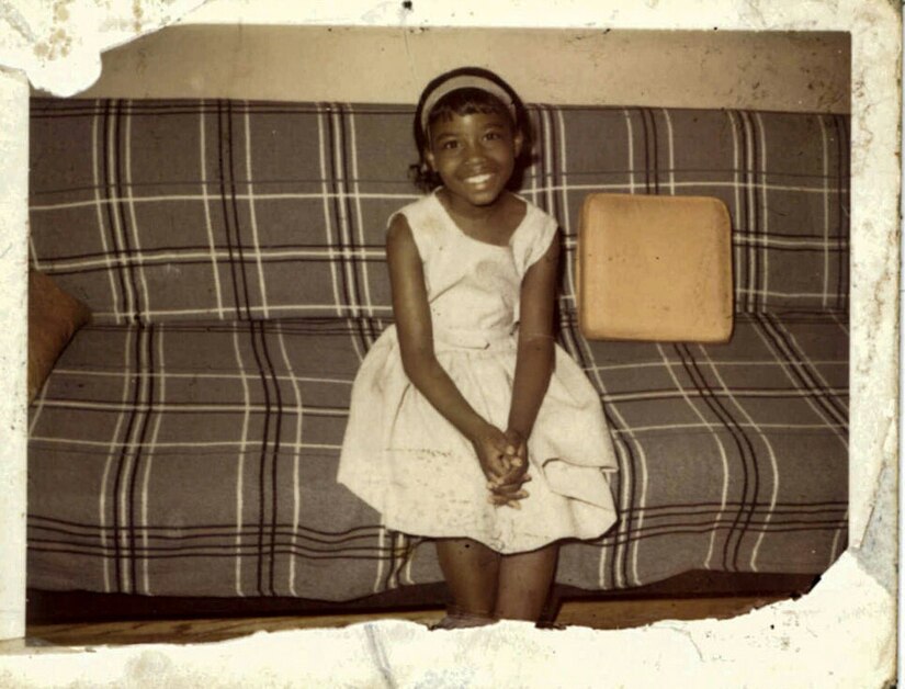 Seven year-old Frances Culpepper on the couch when her family first moved to Chicago from Mississippi. Culpepper worked through the ranks to retire as a Sgt. Major in 2016. (Photo courtesy of her mother).