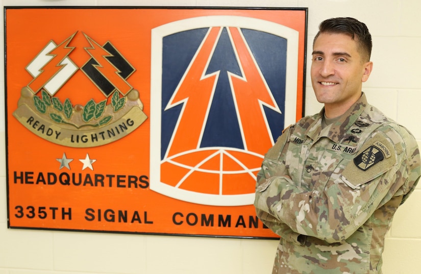 Army Reserve Staff Sgt. Justin P. Morelli, a combat cameraman and the noncommissioned officer-in-charge of training, assigned to the 982nd Combat Camera Company, 335th Signal Command (Theater), poses for a photo at the unit headquarters in East Point, Georgia.  Morelli recently completed the four-week Free fall Parachutist course in Yuma, Arizona, becoming the first Army Reserve combat cameraman to do so.