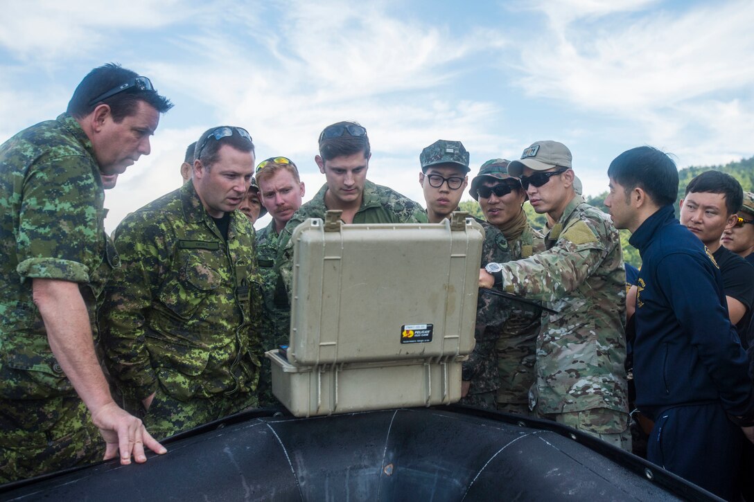 Navy Lt. j.g. Jonathon Ferris reviews the mission data from a MK 18 MOD 1 Underwater Unmanned Vehicle with participants in Clear Horizon in Chinhae, Korea, Oct. 17, 2016. CH16 is a live-action exercise which enhances cooperation and improves capabilities in mine countermeasures operations, with participating nations including South Korea, the United States, Australia, Canada, New Zealand, the Philippines, Thailand, and the United Kingdom. Ferris is assigned to Explosive Ordnance Disposal Mobile Unit 1. Navy photo by Petty Officer 2nd Class Daniel Rolston
