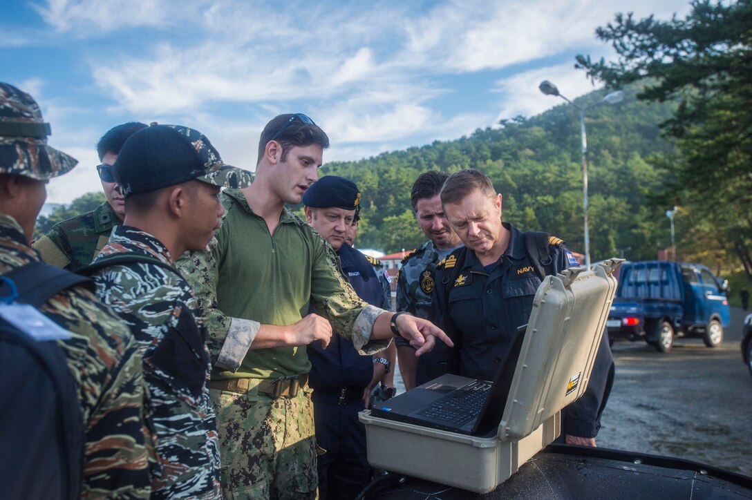 Navy Lt. j.g. Jonathon Ferris reviews the mission data from a MK 18 MOD 1 Underwater Unmanned Vehicle with participants in Clear Horizon in Chinhae, Korea, Oct. 17, 2016. CH16 is a live-action exercise which enhances cooperation and improves capabilities in mine countermeasures operations, with participating nations including South Korea, the United States, Australia, Canada, New Zealand, the Philippines, Thailand, and the United Kingdom. Ferris is assigned to Explosive Ordnance Disposal Mobile Unit 1. Navy photo by Petty Officer 2nd Class Daniel Rolston