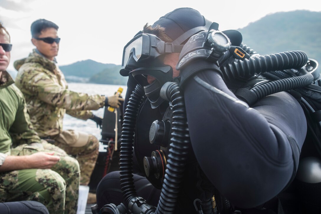 Navy Petty Officer 2nd Class Giancarlo Vanzzini dons the facemask of his Viper rebreather while participating in Clear Horizon in South Korean waters, Oct. 17, 2016. CH16 is a live-action exercise which enhances cooperation and improves capabilities in mine countermeasures operations, with participating nations South Korea, the United States, Australia, Canada, New Zealand, the Philippines, Thailand, and the United Kingdom. , assigned to Explosive Ordnance Disposal Mobile Unit 1. Navy photo by Petty Officer 2nd Class Daniel Rolston