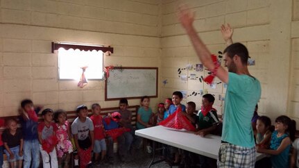 Pfc. Joshua Anderson, a service desk technician at the 335th Signal Command (Theater) headquarters, and a native of Woodstock, Georgia, teaches an English class to children in Siguatepeque, Honduras during a recent volunteer mission a group of volunteers from his church.  The group not only hosted English classes for children, but they also conducted various refurbishing and beautification projects at a seminary there.