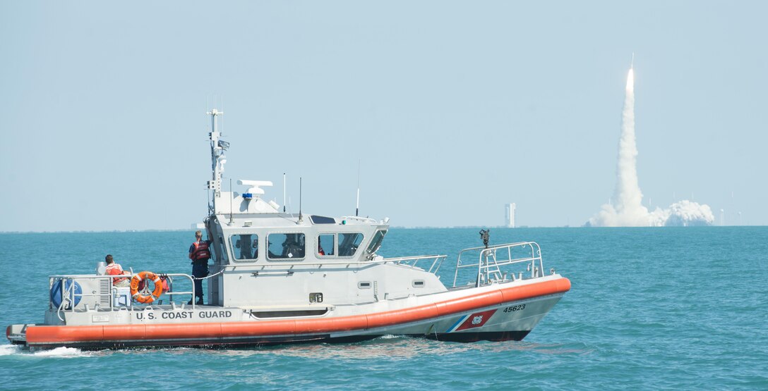 A boatcrew from Coast Guard Station Port Canaveral, Florida, enforces a safety and security zone during a rocket launch from the Kennedy Space Center (off the coast of Cape Canaveral, Fla.), June 24, 2016.