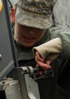 Senior Airman Olivia Christiansen, 5th Communications Squadron intrusion detection system maintenance member, removes a pin from a Remote Target Engagement System in the weapons storage area at Minot Air Force Base, N.D., Oct. 12, 2016. The RTES towers provide around-the-clock security in the WSA. (U.S. Air Force photo/Senior Airman Apryl Hall)