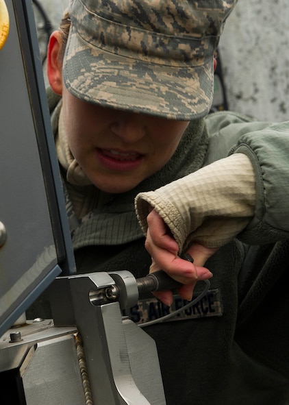 Senior Airman Olivia Christiansen, 5th Communications Squadron intrusion detection system maintenance member, removes a pin from a Remote Target Engagement System in the weapons storage area at Minot Air Force Base, N.D., Oct. 12, 2016. The RTES towers provide around-the-clock security in the WSA. (U.S. Air Force photo/Senior Airman Apryl Hall)