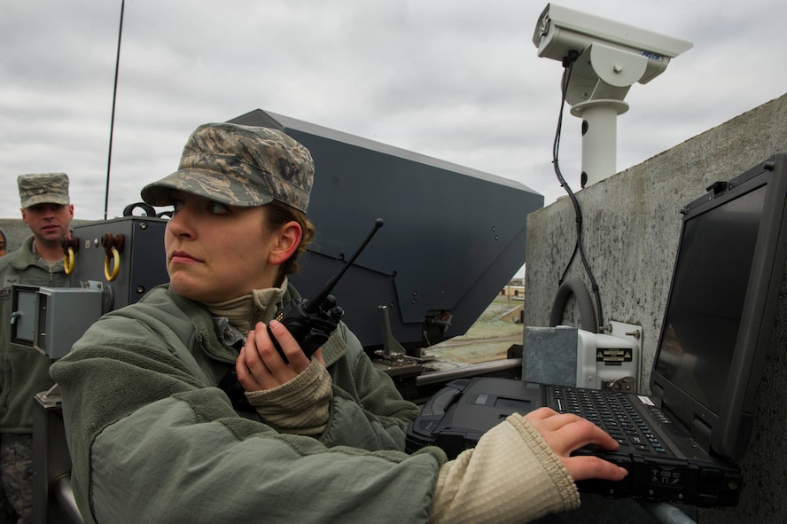 Senior Airman Olivia Christiansen, 5th Communications Squadron intrusion detection system maintenance member, communicates with the control tower in the weapons storage area at Minot Air Force Base, N.D., Oct. 12, 2016. The Remote Target Engagement System towers, which provide around-the-clock security for the WSA, are controlled by Airmen in an undisclosed location. (U.S. Air Force photo/Senior Airman Apryl Hall)