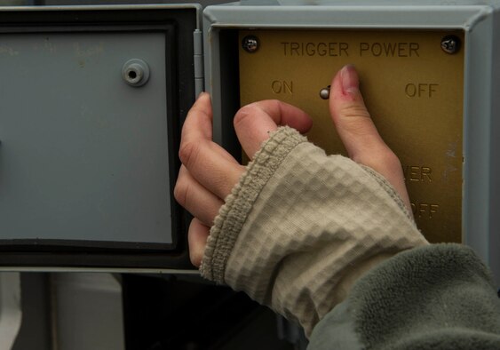 Senior Airman Olivia Christiansen, 5th Communications Squadron intrusion detection system maintenance member, switches a weapons system to on-mode while inspecting Remote Target Engagement System towers in the weapons storage area at Minot Air Force Base, N.D., Oct. 12, 2016. Every 28 days, the RTES’ are inspected to ensure they function properly. (U.S. Air Force photo/Senior Airman Apryl Hall)