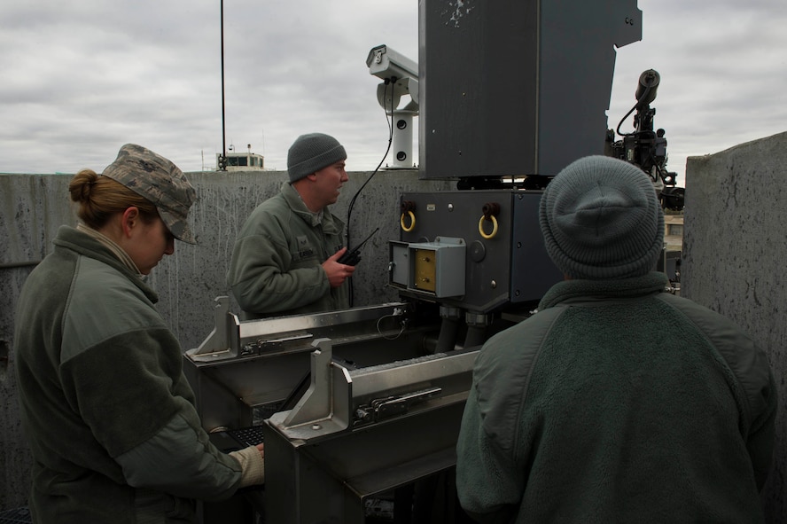 Airmen from the 5th Communications Squadron and combat arms instructors inspect Remote Target Engagement System towers in the weapons storage area at Minot Air Force Base, N.D., Oct. 12, 2016. Preventative maintenance inspections ensure the weapons system functions properly. (U.S. Air Force photo/Senior Airman Apryl Hall)