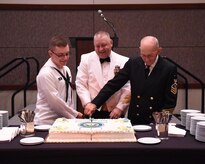 Seaman Charles Diehl (left), Navy Nuclear Power Training Command machinist mate, Master Chief Petty Officer Asa Worcester (center), Joint Base Charleston command master chief and Sam Kirton, a retired Navy Master Chief Petty Officer, cut the cake during the Navy Ball celebrating the Navy’s 241st birthday. The event took place at the Embassy Suites Hotel, Charleston, South Carolina on Oct. 15. Navy tradition is to have the cake cut by the youngest and oldest Navy members present.