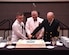 Seaman Charles Diehl (left), Navy Nuclear Power Training Command machinist mate, Master Chief Petty Officer Asa Worcester (center), Joint Base Charleston command master chief and Sam Kirton, a retired Navy Master Chief Petty Officer, cut the cake during the Navy Ball celebrating the Navy’s 241st birthday. The event took place at the Embassy Suites Hotel, Charleston, South Carolina on Oct. 15. Navy tradition is to have the cake cut by the youngest and oldest Navy members present.