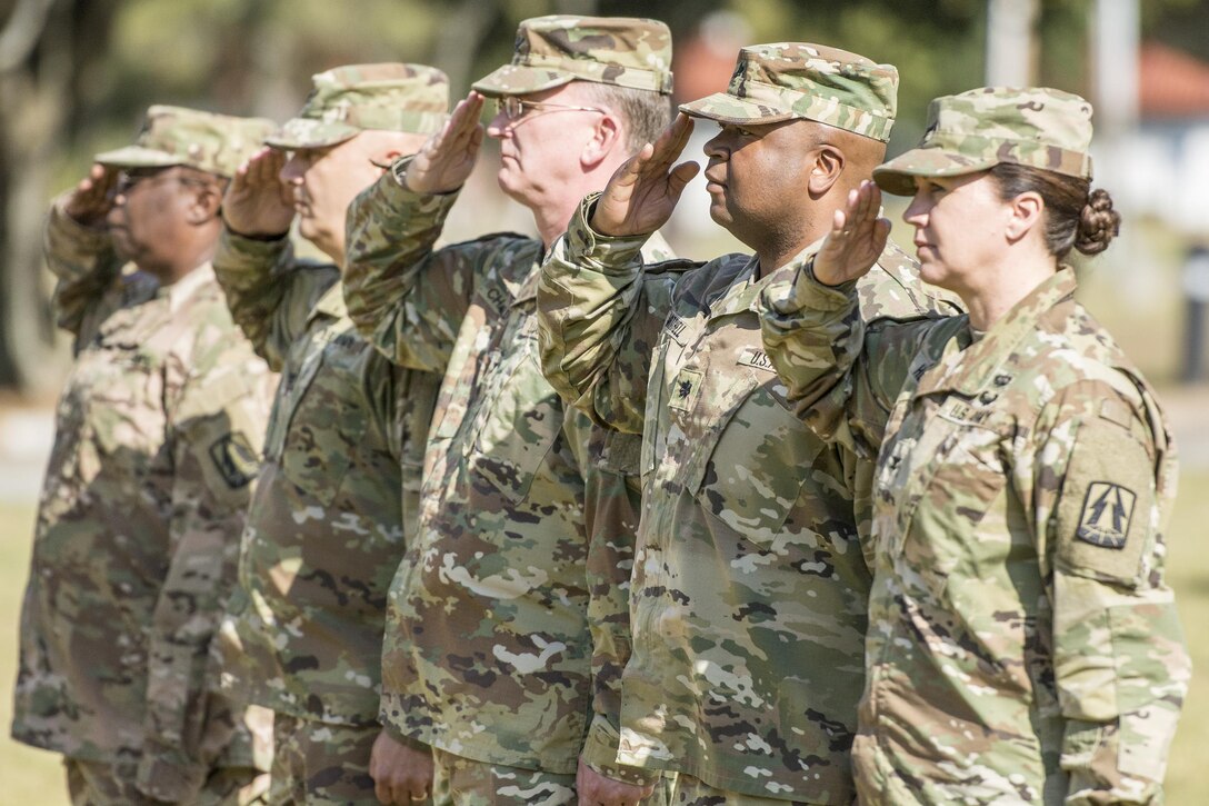 Officers with the U.S. Army Reserve’s 335th Signal Command (Theater) salute during a change of command ceremony at Fort McPherson, Ga., Oct. 15, 2016. U.S. Brig. Gen. Christopher R. Kemp, outgoing commander, relinquished command of the 335th to Brig. Gen. (Promotable) Peter A. Bosse at the ceremony. (U.S. Army photo by Staff Sgt. Ken Scar)