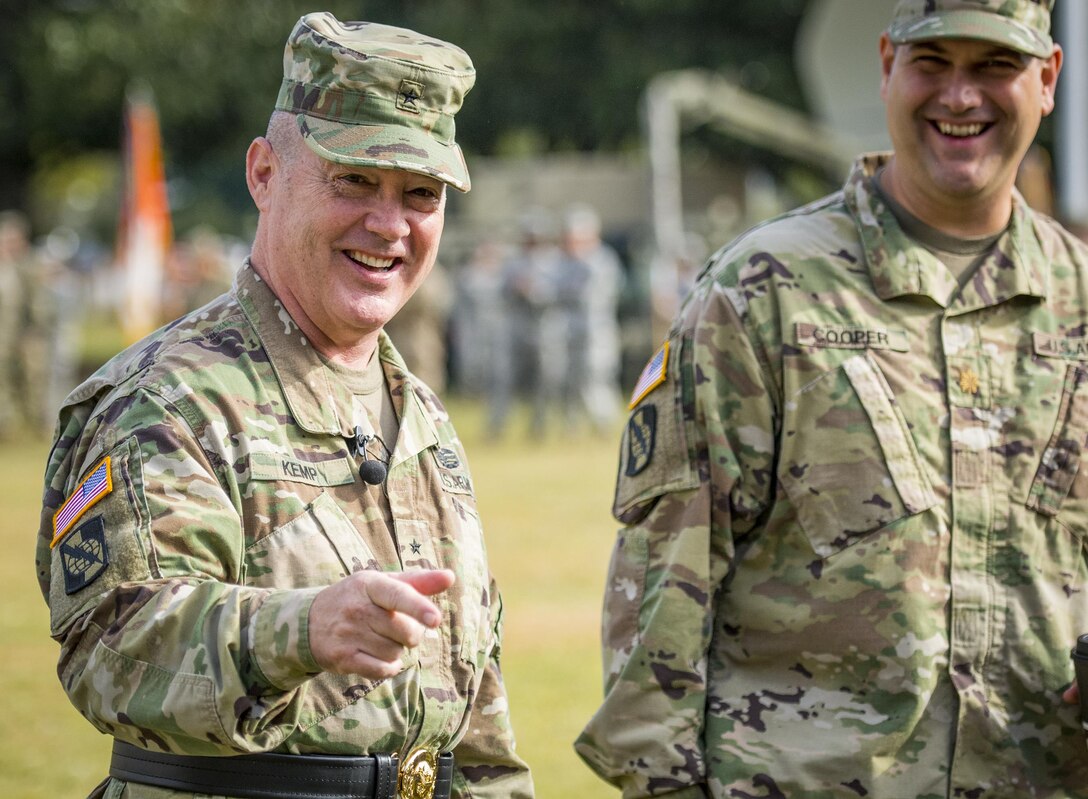 U.S. Reserve Brig. Gen. Christopher R. Kemp, outgoing commander of the 335th Signal Command (Theater), shares a laugh with some of his comrades at his change of command ceremony at Fort McPherson, Ga., Oct. 15, 2016. Kemp relinquished command of the 335th to Brig. Gen. (Promotable) Peter A. Bosse at the ceremony. (U.S. Army photo by Staff Sgt. Ken Scar)