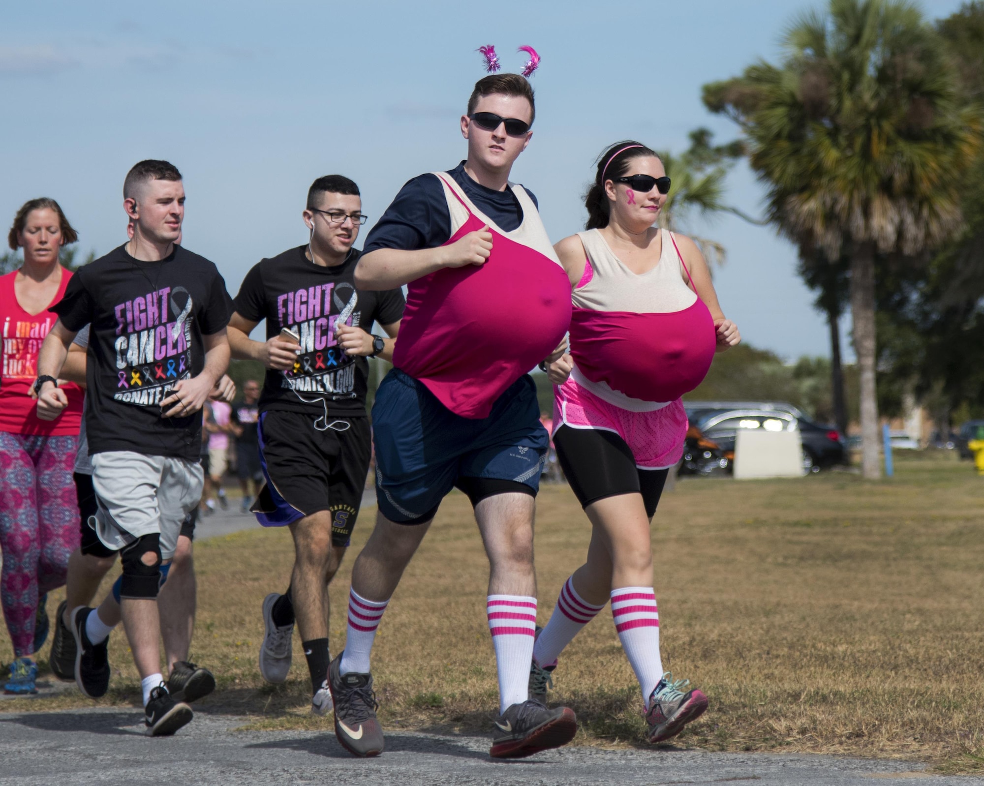 A pair of runners complete the first turn of the annual Breast Cancer Awareness 5k event Oct. 14 at Eglin Air Force Base, Fla.  More than 100 runners and walkers, many sporting pink clothing, came out to support the affair.  The event was held to promote breast cancer awareness and the importance of self-examination to catch the disease in its early stages. (U.S. Air Force photo/Samuel King Jr.)