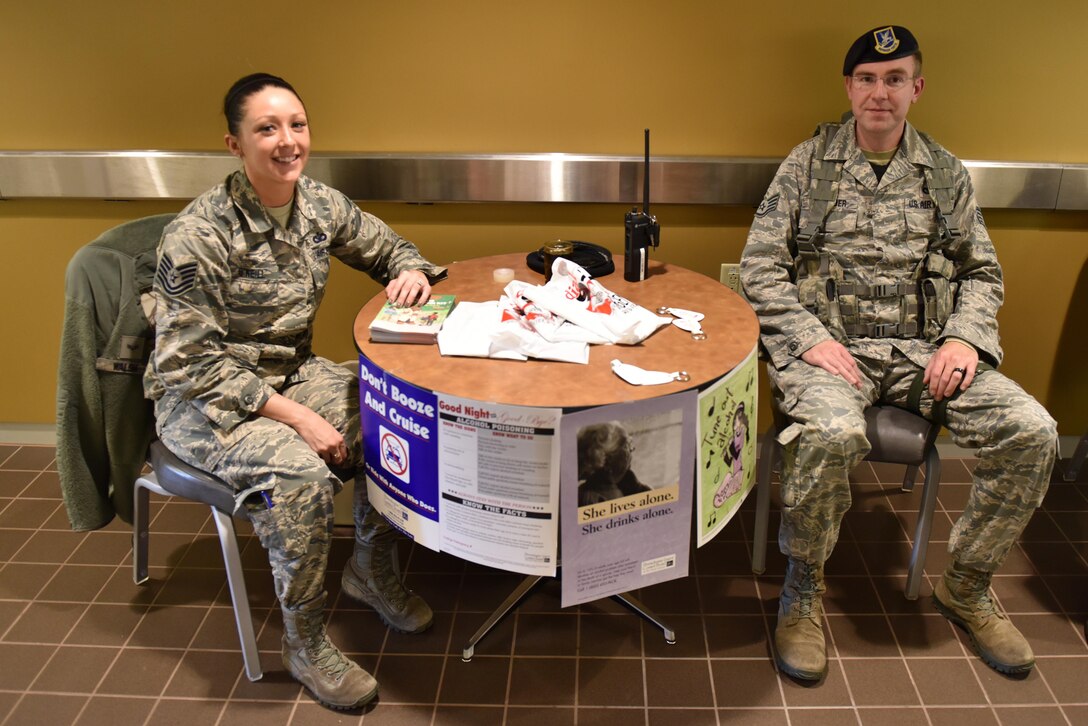 Tech. Sgt. Kayla O’Neill, police services manager with the 911th Security Forces Squadron, and Staff Sgt. Randal Levander, security response team leader with the 911th SFS, run a table to promote good habits to prevent crime in honor of Crime Prevention Month at the Pittsburgh International Air Reserve Station, Pa., Oct. 15, 2016. Ways to avoid being a victim include not traveling in uniform, installing antivirus programs on electronic devices and always having a wingman. (U.S. Air Force photo by Staff Sgt. Marjorie A. Bowlden)