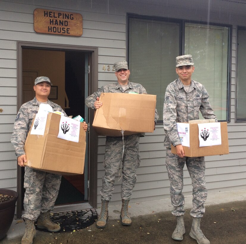 Technical Sgt. Zachary Palomo, Senior Airman Brian Dooley, and Senior Airman Jonathan Jones, from the 446th Operations Support Squadron, delivered donations Oct. 16, 2016, to the Helping Hand House charity organization in Puyallup, Wash. Rainier Wing Airmen delivered more than 300 toiletry and sanitary items to those in need. (U.S. Air Force Reserve photo by 2nd Lt. Alyssa Hudyma/Released)