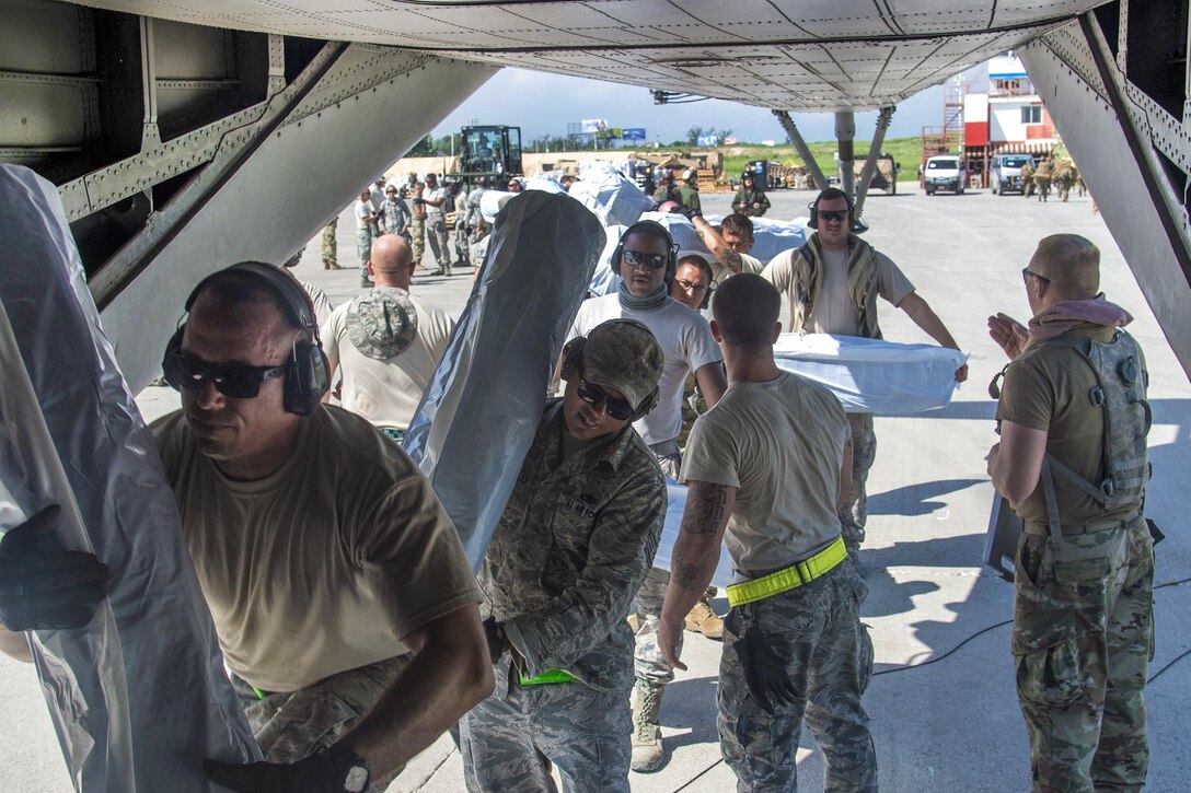 Airmen load humanitarian supplies onto a CH-35E Super Stallion helicopter in Port-au-Prince, Haiti, Oct. 16, 2016. Air Force photo by Staff Sgt. Robert Waggoner 