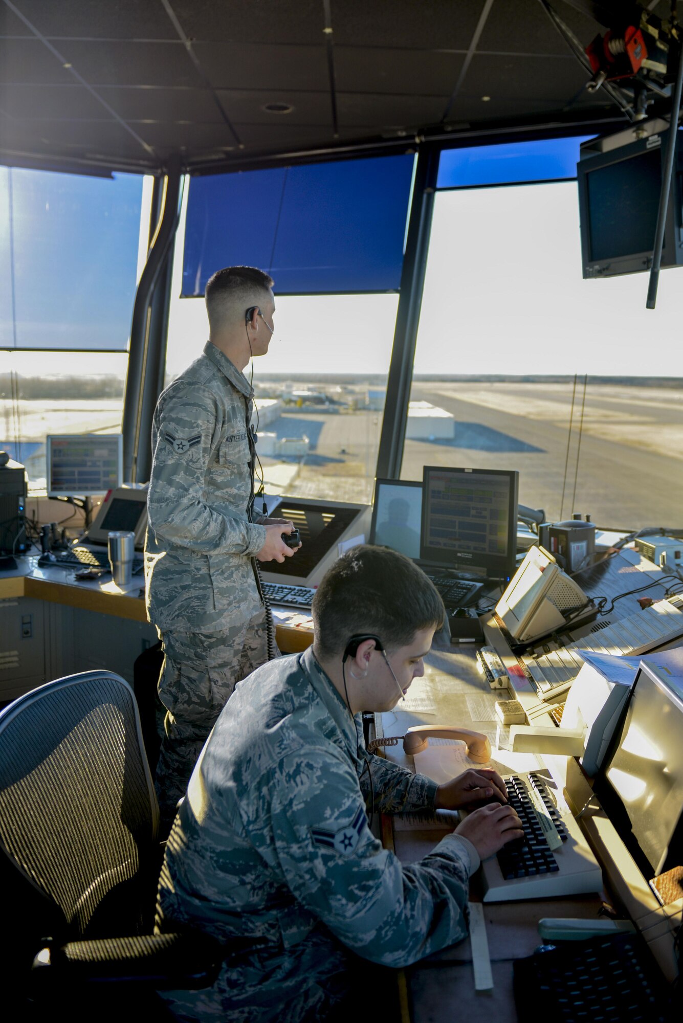 U.S. Air Force Airmen 1st Class Kevin Winter Molins and Ricardo Alvarez, both 354th Operations Support Squadron air traffic control apprentices, monitor the runway and check flight records Oct. 6, 2016, at Eielson Air Force Base, Alaska. Air traffic controllers play a large role in takeoffs and landings running smoothly. (U.S. Air Force photo by Airman Isaac Johnson)