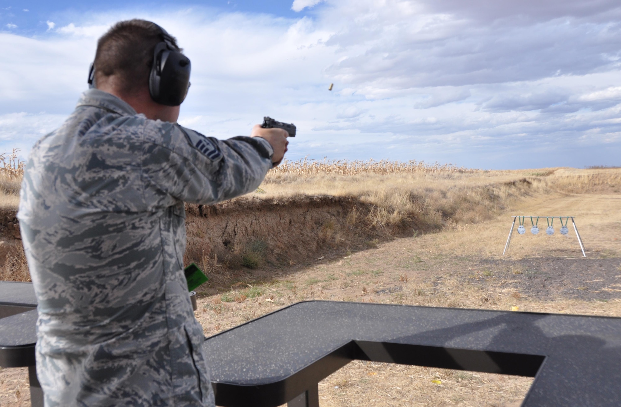 Master Sgt. Derek Perrault, Air Reserve Personnel Center training manager, shoots his pistol during practice at a firing range in Watkins, Colo., Oct. 3. Perrault earned his U.S. Air Force Elementary Excellence in Competition (EIC) Pistol Badge during a firearm match at the Air Force Academy in Colorado Springs, Colo., in September. (U.S. Air Force photo by Tech. Sgt. Beth Anschutz)