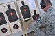 Master Sgt. Derek Perrault, Air Reserve Personnel Center training manager, staples targets before pistol practice at a firing range in Watkins, Colo., Oct. 3. Perrault earned his U.S. Air Force Elementary Excellence in Competition (EIC) Pistol Badge during a firearm match at the Air Force Academy in Colorado Springs, Colo., in September. (U.S. Air Force photo by Tech. Sgt. Beth Anschutz)