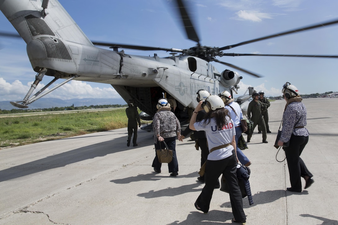 Members of the United States Agency for International Development’s Disaster Assistance Response Team board a CH-53E Super Stallion helicopter at Port-au-Prince, Haiti, Oct 16, 2016. The Marines and sailors with the 24th Marine Expeditionary Unit aboard the USS Iwo Jima have been providing assistance to the U.S. government’s civil humanitarian aid and disaster relief efforts in Haiti in the wake of Hurricane Matthew. Marine Corps photo by Cpl. Hernan Vidana