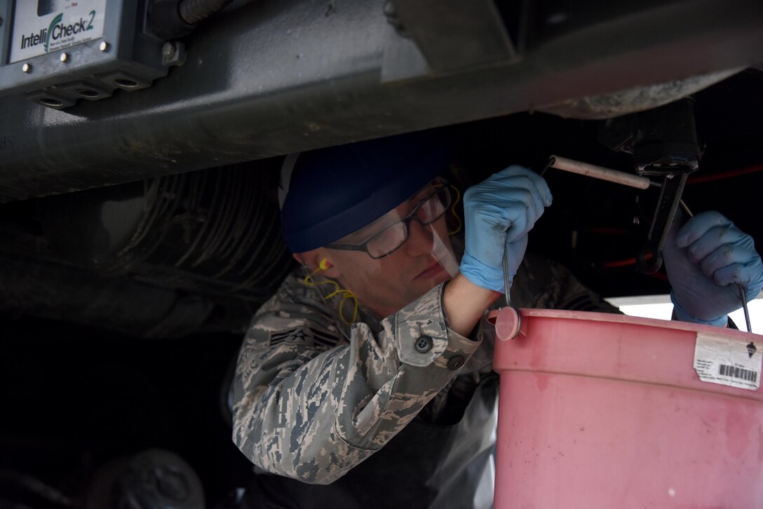 Senior Airman Stuart Brennan, member of the 911th Petroleum, Oil and Lubricants Flight, drains residue out of the fuel tank of an R-11 fuel truck at the Pittsburgh International Airport Air Reserve Station, Oct. 16, 2016. Brennan found that a fuel sample from the tank was cloudy and drained the contaminated fuel to prevent possible damage to the aircraft. (U.S. Air Force photo by Staff Sgt. Marjorie A. Bowlden)