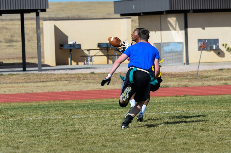 Tyrelle Shepherd, 3rd Space Operations Squadron, catches the first of his three touchdown passes during the first half of the intramural flag football championship game at Schriever Air Force Base, Colorado, Thursday, Oct. 13, 2016. Shepherd’s scores weren’t enough as 3 SOPS fell to the 1st Space Operations Squadron 35-18. (U.S. Air Force photo/Christopher DeWitt)