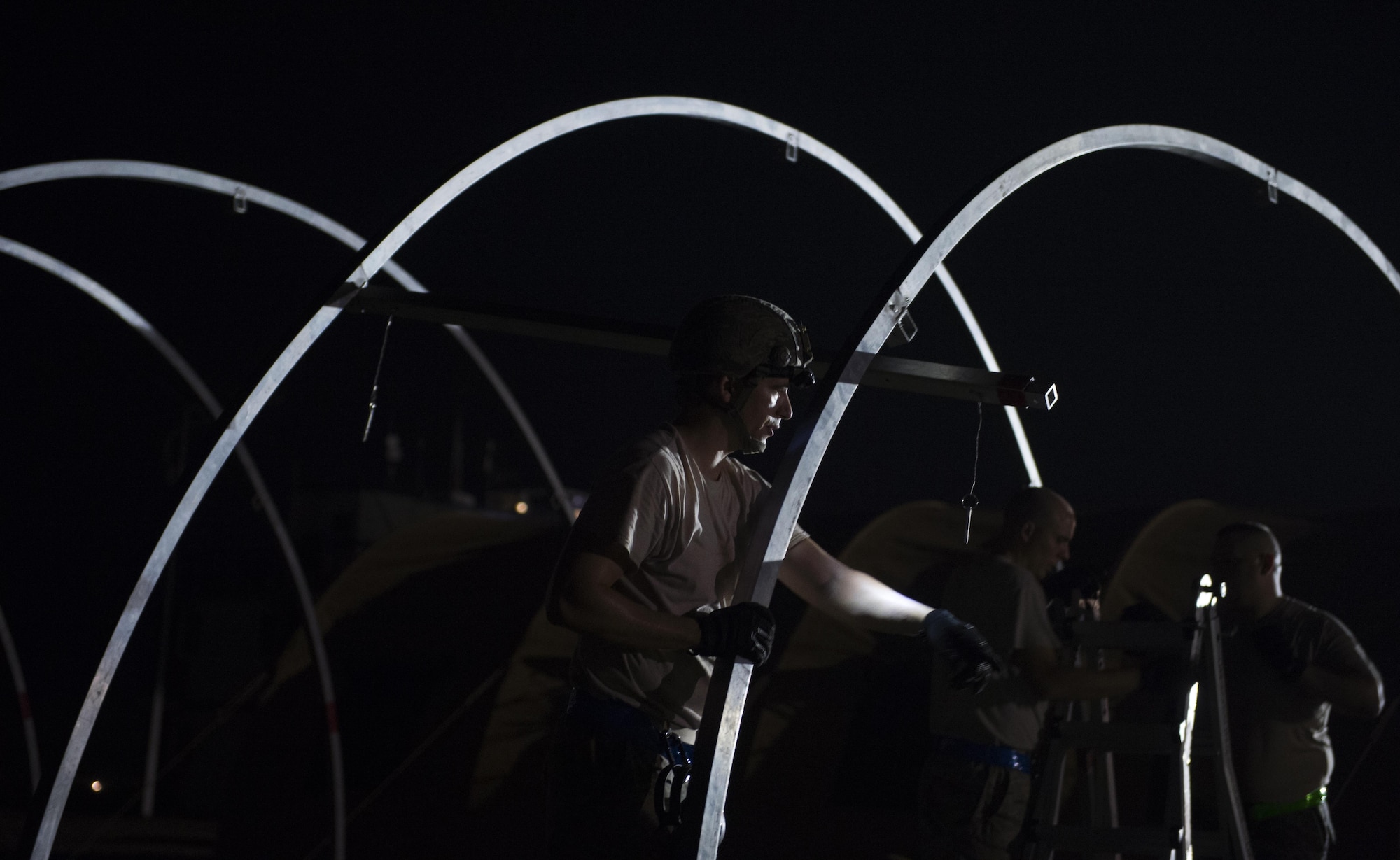 Airmen from the 621st Crisis Response Wing work together to build sleeping tents on an airfield in Port-au-Prince, Haiti, Oct 9, 2016. Since arriving Oct. 5, U.S. service members assigned to Joint Task Force Matthew have been operating around the clock, providing aid to citizens of western Haiti. (U.S. Air Force photo/Staff Sgt. Paul Labbe)