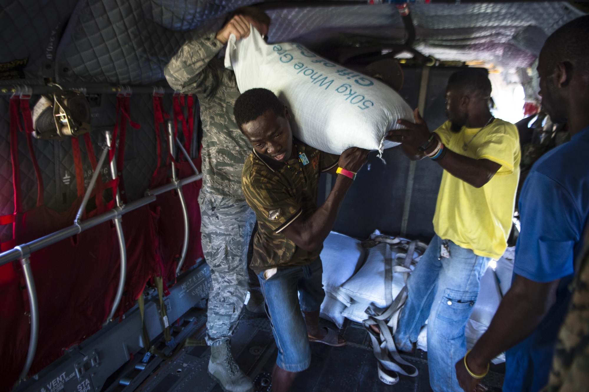 U.S. service members and citizens of Beaumont, Haiti, unload supplies from a CH-47 Chinook Oct. 13, 2016. Service members part of Joint Task Force Matthew have delivered more than 440 tons of supplies to Haitians affected by Hurricane Matthew. (U.S. Air Force photo/Tech. Sgt. Russ Scalf)