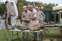 MCSC commander BGen Joseph Shrader examines the individual protective equipment used by Marines during the Infantry Equipping Challenge's Industry Day on September 26, 2016.