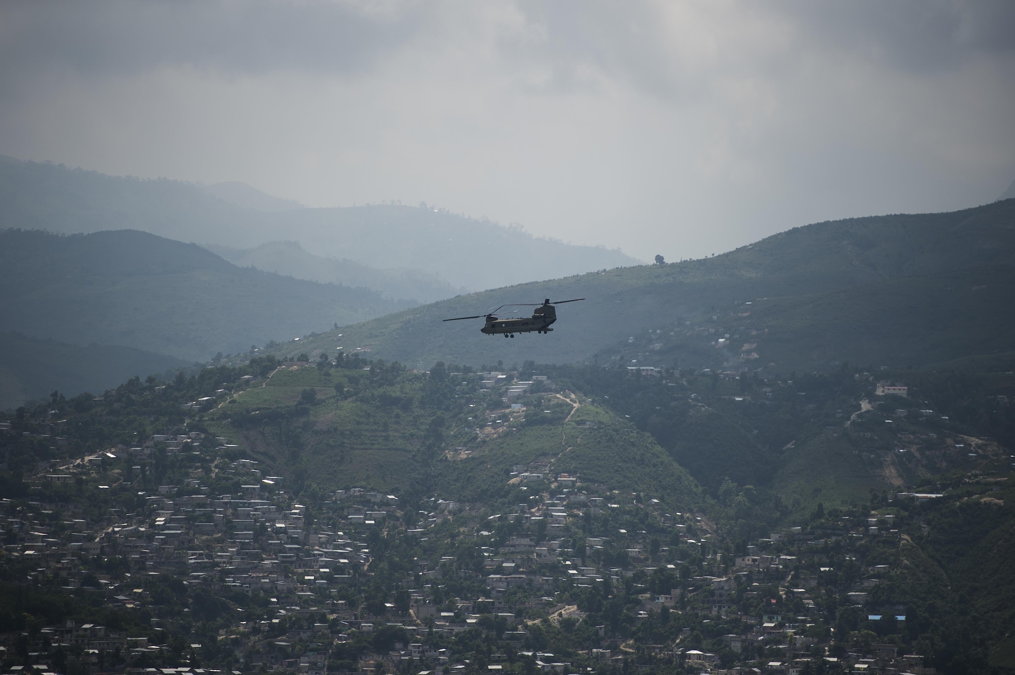 An Army CH-47 Chinook returns to Port-au-Prince, Haiti, Oct. 10, 2016. The aircraft delivered aid in support of Joint Task Force Matthew’s mission of providing humanitarian aid to those affected by Hurricane Matthew. (U.S. Air Force photo/Tech. Sgt. Russ Scalf)