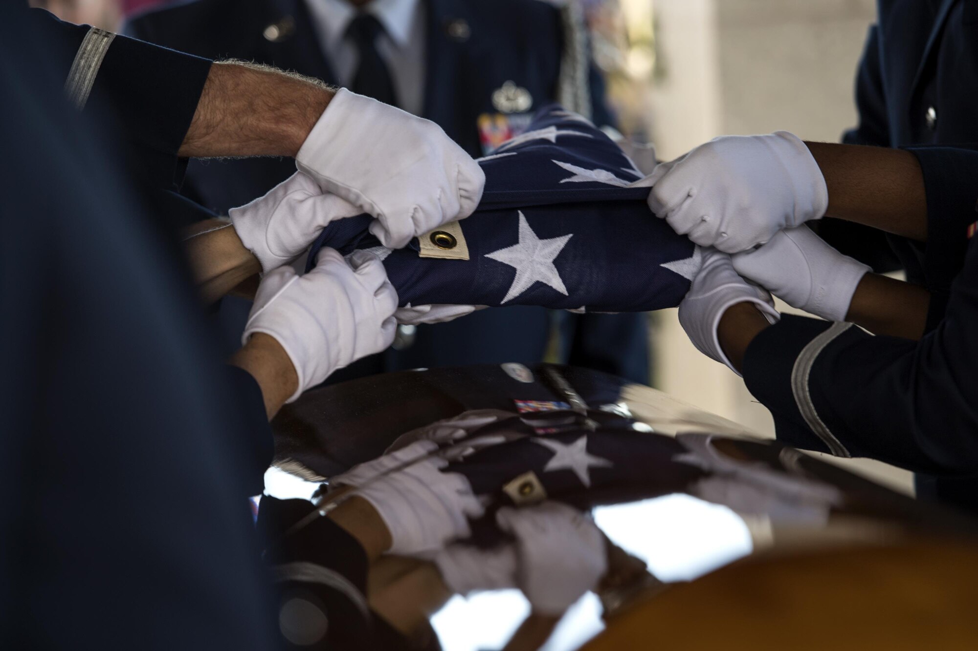 Members of the Moody Air Force Base Honor Guard fold the United States flag during a funeral, Oct. 13, 2016, in Jacksonville, Fla. The pallbearers work together to ensure the flag is folded properly before presenting it to a loved one. (U.S. Air Force photo by Airman 1st Class Janiqua P. Robinson)