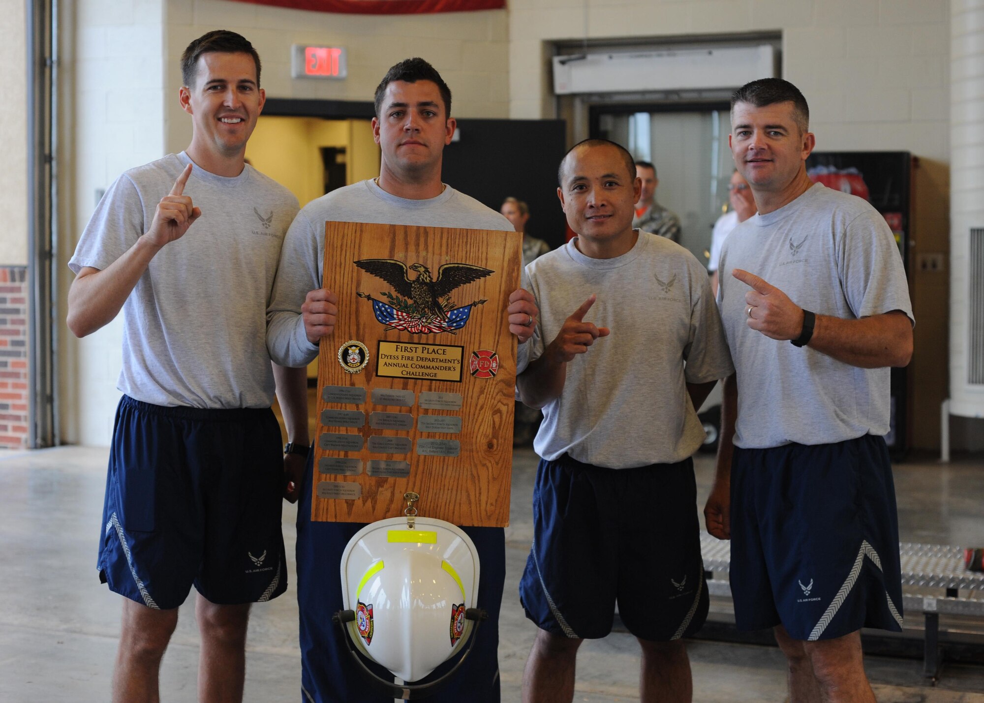 From left to right, U.S. Air Force Major Tyler Johnson, Staff Sgt. Michael Forcier, Master Sgt. Galli Delfin, and Master Sgt. Ricky Johnson receive the first place award for the Fire Muster at Dyess Air Force Base, Texas, Oct. 14, 2016. Twelve teams of four Airmen each participated in the event, giving them the opportunity to learn the process of emergency response. (U.S. Air Force photo by Airman 1st Class Rebecca Van Syoc)