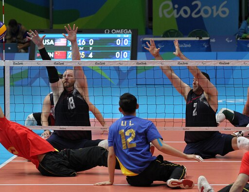 U.S. Paralympian J. Dee Marinko, No. 18, left, prepares to block the ball during the Sept. 16 sitting volleyball match versus China. Team USA played four matches against tough competition during the 2016 Paralympic Games in Rio de Janeiro. Marinko is a production controller with the 550th Commodities Maintenance Squadron. (Photo by John Kessel)