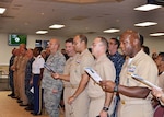 Senior leaders and guests join in singing “Anchors Aweigh” at the conclusion of the 241st Navy birthday celebration Oct. 13, 2016 in the Center Restaurant on Defense Supply Center Richmond, Virginia. 