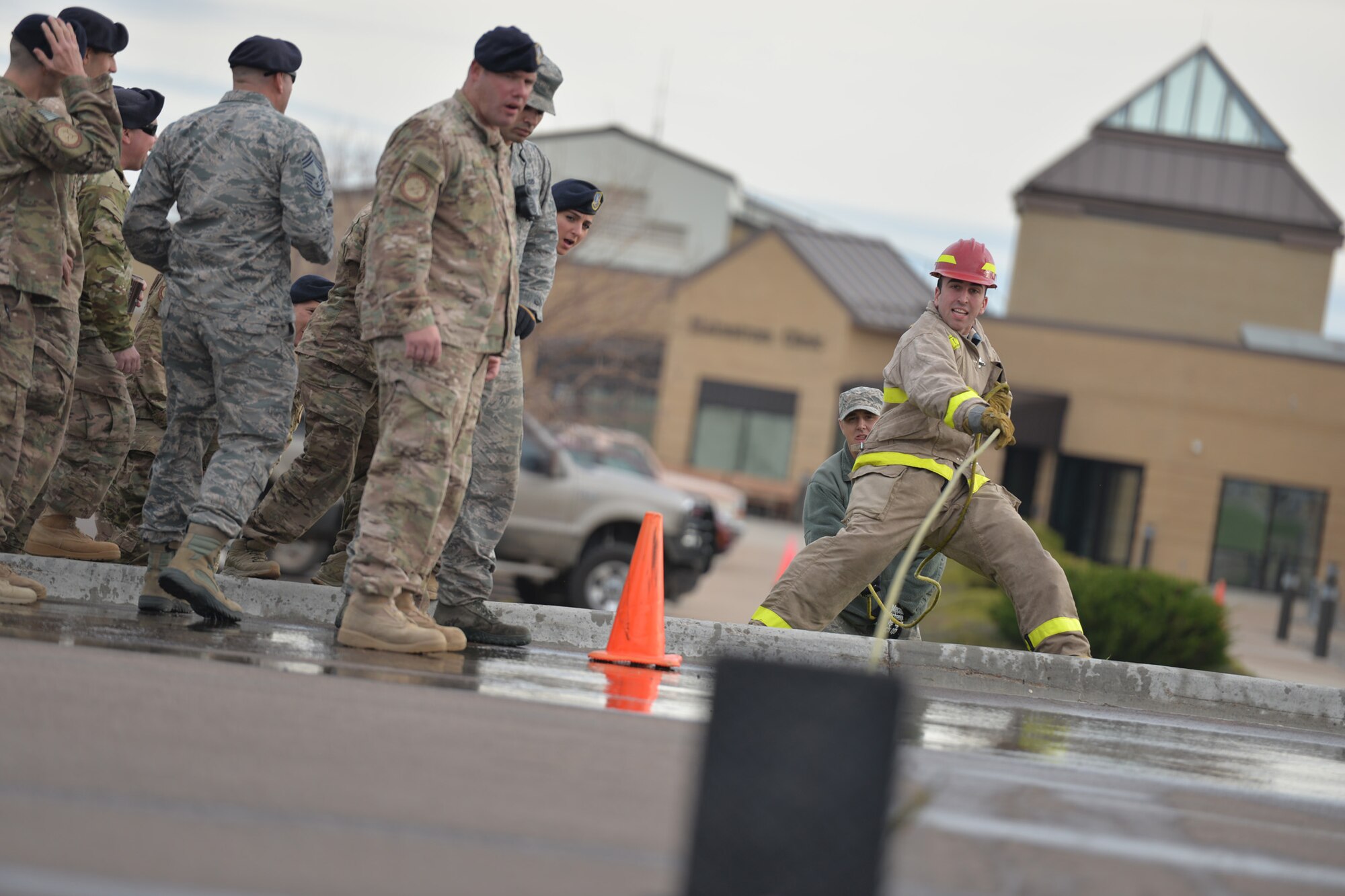 An Airman participates in a fire muster competition during Fire Prevention Week Oct. 14, 2016, at Malmstrom Air Force Base, Mont. The competition tested speed and strength in completing a seven obstacle course. (U.S. Air Force photo/Airman 1st Class Daniel Brosam)