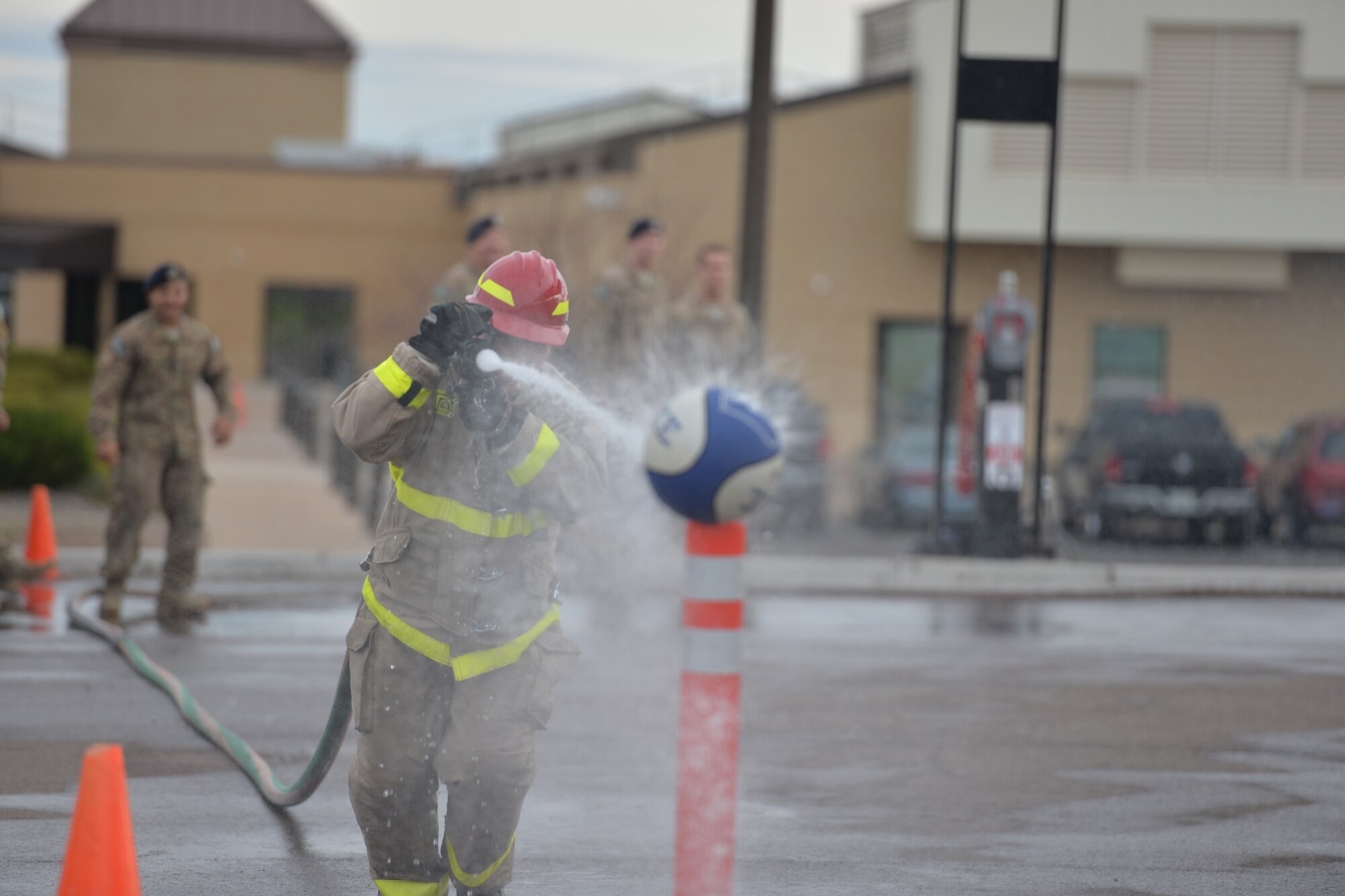 An Airman participates in a fire muster competition during fire prevention week Oct. 14, 2016, at Malmstrom Air Force Base, Mont. The event included donning fire gear, pulling a 170-pound sled, dousing a simulated flame-engulfed building with buckets of water and dragging a human-sized mannequin to safety. (U.S. Air Force photo/Airman 1st Class Daniel Brosam)