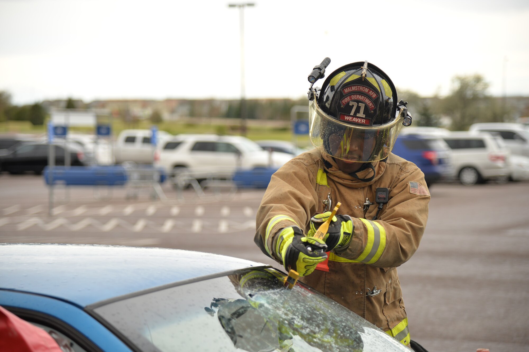 Airman 1st Class Justin Weaver, 341st Civil Engineer Squadron firefighter, cuts the windshield of a car during a vehicle extrication simulation Oct. 14, 2016, at Malmstrom Air Force Base, Mont. As part of Fire Prevention Week, Malmstrom’s Fire Department held events Oct. 10-15 to raise awareness about fire prevention and safety. (U.S. Air Force photo/Airman 1st Class Daniel Brosam)