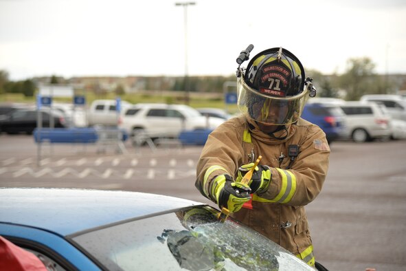Airman 1st Class Justin Weaver, 341st Civil Engineer Squadron firefighter, cuts the windshield of a car during a vehicle extrication simulation Oct. 14, 2016, at Malmstrom Air Force Base, Mont. As part of Fire Prevention Week, Malmstrom’s Fire Department held events Oct. 10-15 to raise awareness about fire prevention and safety. (U.S. Air Force photo/Airman 1st Class Daniel Brosam)