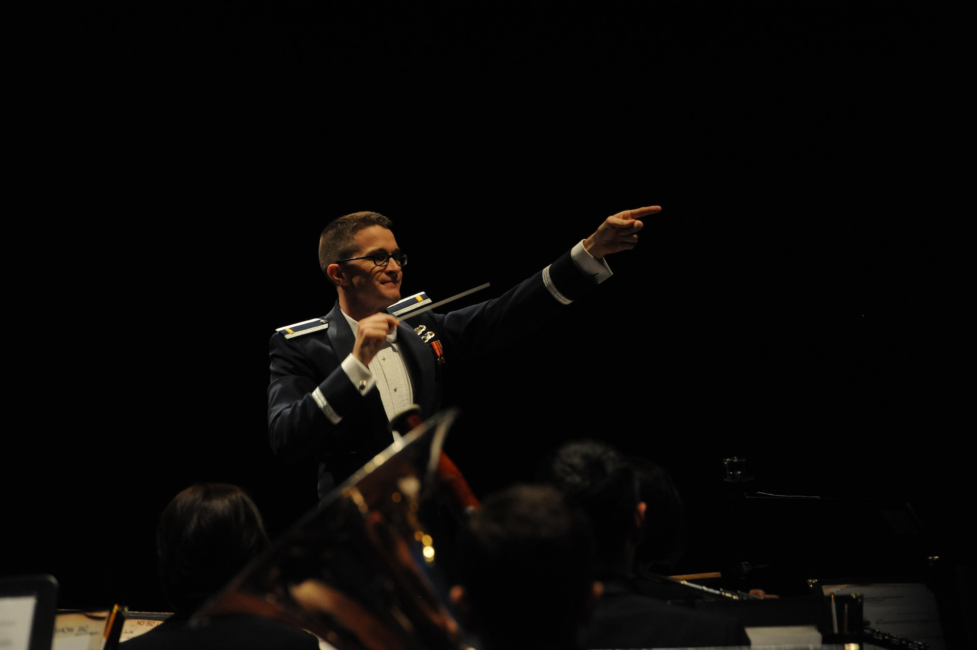 2nd Lt. Philip Emery, U.S. Air Force Heritage of America Band flight commander and associate conductor, conducts during a USAF HOAB 75th Anniversary Band Concert at the Ferguson Center for the Arts in Newport News, Va., Oct. 1, 2016. Since its creation, the band has represented the Air Force at musical and military events. This concert represented the band’s 75 years of heritage since it was first established in 1941. (U.S. Air Force photo by Staff Sgt. Nick Wilson)