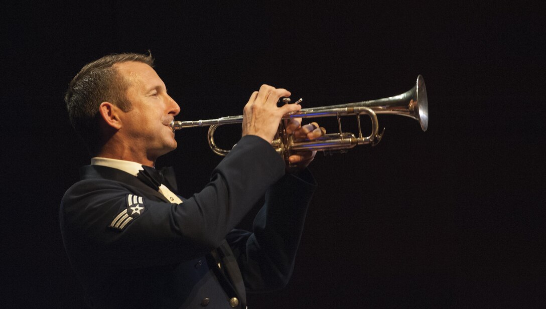 Senior Airman Mark Oates, U.S. Air Force Heritage of America Band trumpet player, plays a solo during a USAF HOAB 75th Anniversary Band Concert at the Ferguson Center for the Arts in Newport News, Va., Oct. 1, 2016. Oates received a Bachelor's of Music degree from James Madison University where he was the second brass player in University history to win the annual concerto competition, and was twice selected as a member of the All-American Band. (U.S. Air Force photo by Staff Sgt. Nick Wilson)