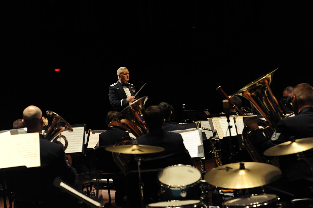 Col. (Ret.) Larry H. Lang, former U.S. Air Force Heritage of America Band director, conducts during a USAF HOAB 75th Anniversary Band Concert at the Ferguson Center for the Arts in Newport News, Va., Oct. 1, 2016. In 2005, Lang was inducted into the prestigious American Bandmasters Association. He is also a member of numerous musical associations and is active as a guest conductor throughout the United States and abroad. (U.S. Air Force photo by Staff Sgt. Nick Wilson)
